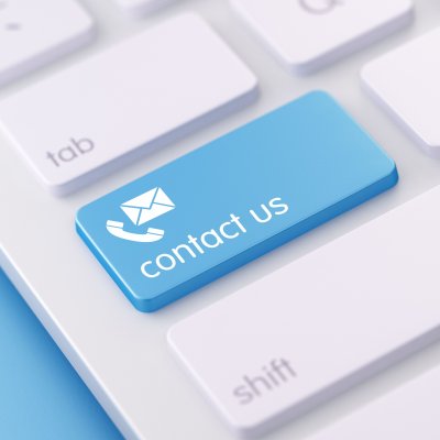 photograph of the corner of a computer keyboard with a blue key tab with the words contact us